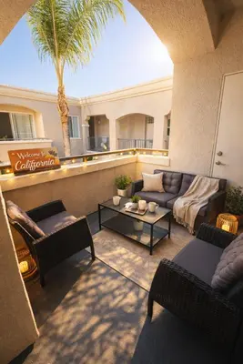 a living room with couches and a palm tree at Coastal Modern in MDR in Los Angeles