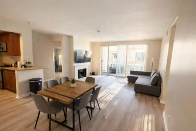a living room with a table and chairs and a kitchen at Boardwalk & Marina Retreat in Los Angeles