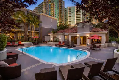 a swimming pool with chairs and a building at Marina del Rey Modern 2BR 2BA & Near Venice Beach Boardwalk in Los Angeles