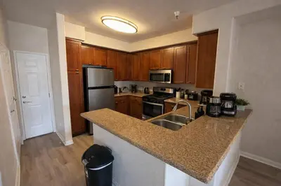 a kitchen with wooden cabinets and a granite counter top at Marina del Rey Spacious 2BR 2BA - Venice Beach Minutes Away in Los Angeles