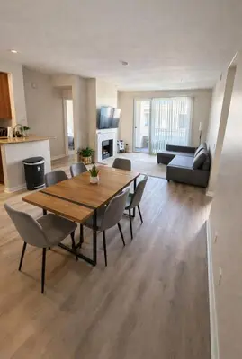 a living room with a wooden table and chairs at Marina del Rey Modern 2BR - Venice in Los Angeles
