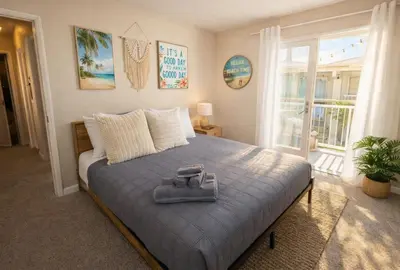 a bedroom with a bed with a blue blanket and a window at Marina del Rey Modern 2BR - Venice in Los Angeles