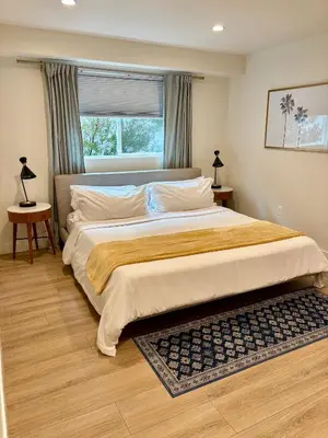 a large bed in a bedroom with a window at Modern 3Bedroom 3Bath Townhouse in Sherman Oaks