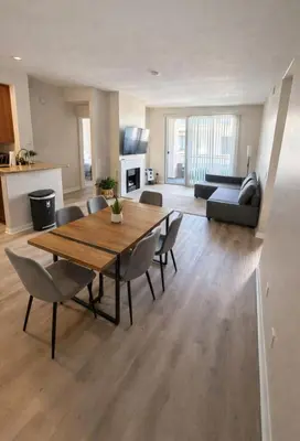 a living room with a wooden table and chairs at Marina del Rey Comfort Stay - Venice in Los Angeles