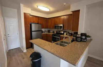 a kitchen with wooden cabinets and a granite counter top at Marina del Rey 2BR-2BA Near Venice Boardwalk in Los Angeles