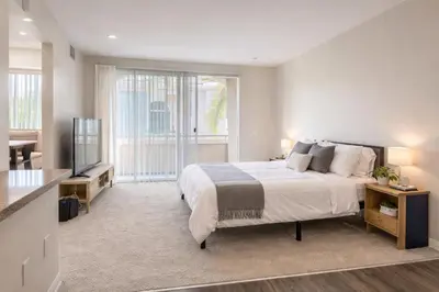a bedroom with a large bed and a television at Marina del Rey 1BR -- Near Venice Beach in Los Angeles