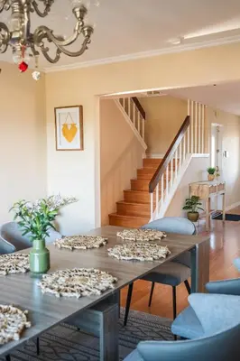 a dining room with a table and stairs at Beautiful Monterey Park Home With a View, Backyard and BBQ in Monterey Park