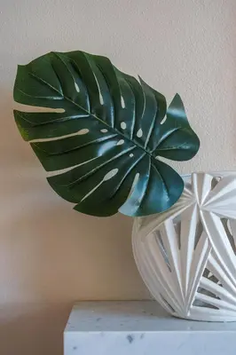 a green plant in a white vase on a table at Beautiful Monterey Park Home With a View, Backyard and BBQ in Monterey Park