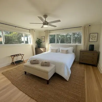a bedroom with a white bed and a ceiling fan at Altadena Retreat Near Rose Bowl and Pasadena in Altadena