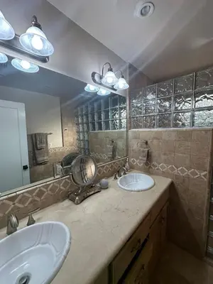 a bathroom with two sinks and a large mirror at Altadena Retreat Near Rose Bowl and Pasadena in Altadena
