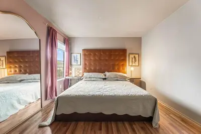 a bedroom with a large bed and a large mirror at Elegant Luxe Hampton inspo Retreat in Glendale, CA in Glendale