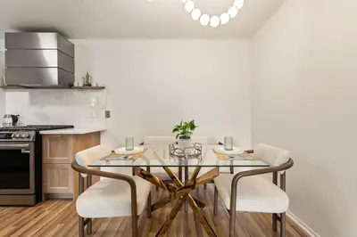 a kitchen with a glass table and chairs at Elegant Luxe Hampton inspo Retreat in Glendale, CA in Glendale