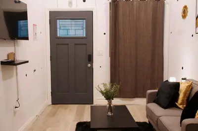 a living room with a door and a couch at Noir and Gold Retreat in Los Angeles