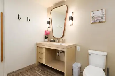 a bathroom with a sink and a mirror at 2Bed Apt View of Hollywood Sign & Rooftop Pool in Los Angeles