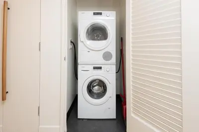 a washer and dryer in a laundry room at 2Bed Apt View of Hollywood Sign & Rooftop Pool in Los Angeles