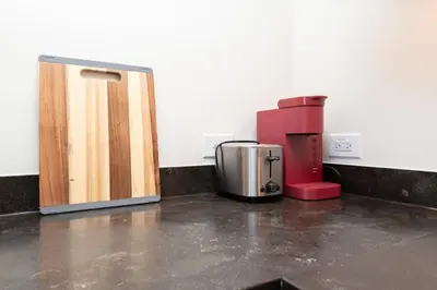 a coffee maker and a door in a room at 2Bed Apt View of Hollywood Sign & Rooftop Pool in Los Angeles