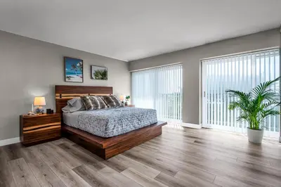 a bedroom with a bed and a large window at Marina Chic Apartment! Free Parking in Los Angeles