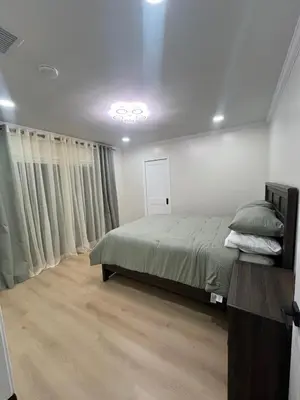 a bedroom with a large bed and a window at Modern Family 3BR Near LAX & Disney in Torrance