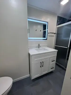 a white bathroom with a sink and a mirror at Modern Family 3BR Near LAX & Disney in Torrance