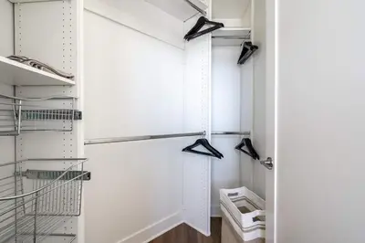 a white closet with hangers and a glass door at Sleek Marina Den, Central, Gym, Pool, King Bed in Los Angeles