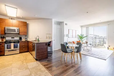 a kitchen and living room with a table and chairs at Sleek Marina Den, Central, Gym, Pool, King Bed in Los Angeles