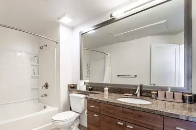 a bathroom with a sink and a toilet and a mirror at Sleek Marina Den, Central, Gym, Pool, King Bed in Los Angeles