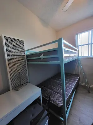 a bunk bed in a room with a desk and bunk beds at Bunk bed spot available, Central LA in Los Angeles