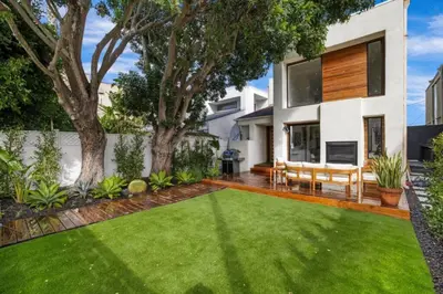 a house with a green lawn in front of it at Pacific Breeze - Modern Venice Beach Home in Los Angeles