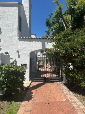 an entrance to a white building with a gate at 3 bedroom plus 2 baths in Beverly hills in Los Angeles