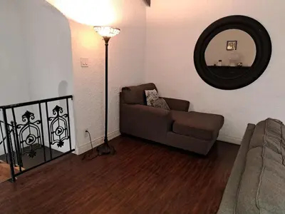 a living room with a couch and a mirror at 3 bedroom plus 2 baths in Beverly hills in Los Angeles