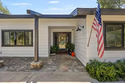 a house with an american flag in front of it at Luxury Ojai Escape Pool, Jacuzzi & Tennis Court in Ojai