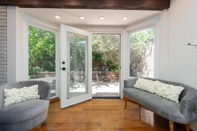 two gray couches in a living room with sliding glass doors at Sunset villa in Los Angeles