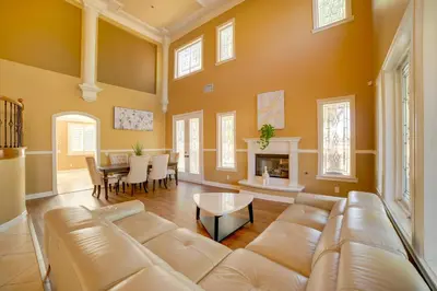 a living room with a couch and a table at Resort-Style Oasis Expansive Riverside Mansion in Riverside