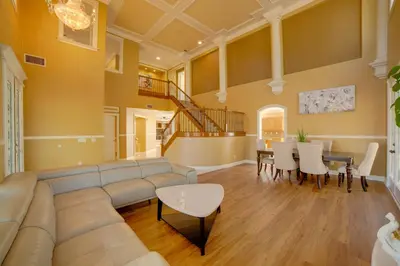 a living room with a couch and a table at Resort-Style Oasis Expansive Riverside Mansion in Riverside