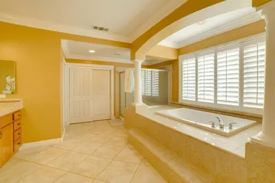 a large bathroom with a tub and a window at Resort-Style Oasis Expansive Riverside Mansion in Riverside