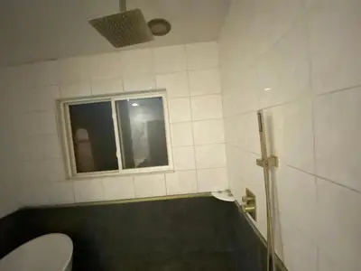 a bathroom with a tub and a toilet and a window at Pet Friendly Private Guest Suite in Northridge in Northridge