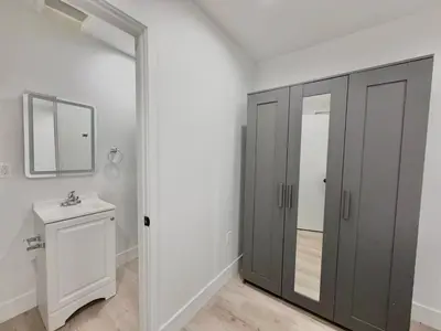a bathroom with a closet and a mirror and a sink at 1622 Palm Terrace in Los Angeles
