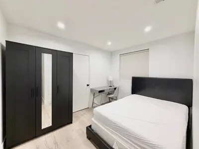 a bedroom with a black bed and a desk at 1622 Palm Terrace in Los Angeles