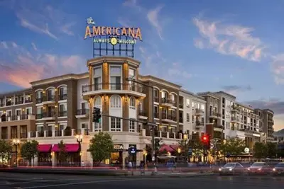 a large building with a sign on top of it at Penthouse Escape Pool Views in Glendale