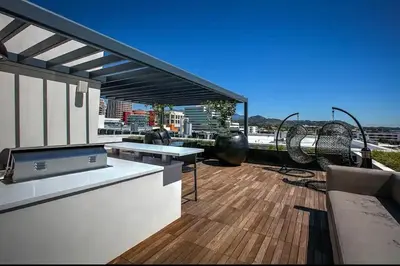a rooftop patio with tables and chairs on a building at Penthouse Escape Pool Views in Glendale