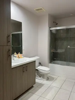 a bathroom with a toilet and a sink and a tub at Penthouse Escape Pool Views in Glendale