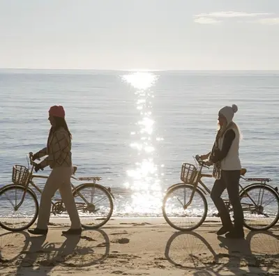 two women walking their bikes on the beach at Drift & Dream - Opulent 1BR Marina Escape in Los Angeles