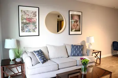 a living room with a white couch and a mirror at Santa Monica Place with Free Parking in Los Angeles