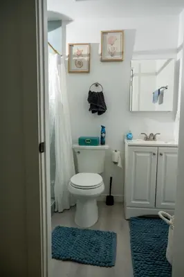 a bathroom with a white toilet and a sink at Beach House by LA Coast in Torrance
