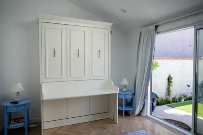 a kitchen with white cabinets and a large window at Beach House by LA Coast in Torrance
