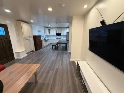 a living room with a large flat screen tv on a wall at Cozy 2-Bedroom Retreat Home in East Los Angeles in Hacienda Heights