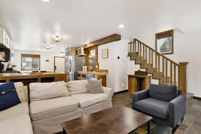 a living room with a couch and a table at Ursa Major Lodge | Walk to Lake & Village | Pet Friendly Retreat in Big Bear Lake