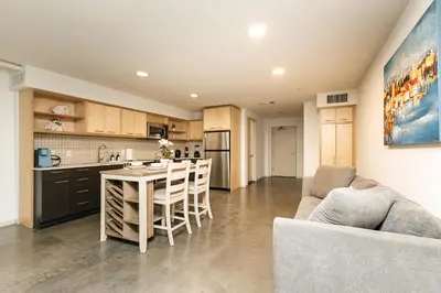 a kitchen and living room with a table and chairs at Fabulous and Spacious 2 level LOFT with Pool GyM Parking in Los Angeles