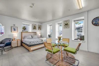 a bedroom with a bed and a table and chairs at Grand Studio On The Promenade Free Parking in Los Angeles