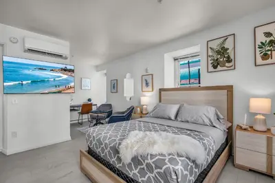 a bedroom with a bed and a flat screen tv at Grand Studio On The Promenade Free Parking in Los Angeles